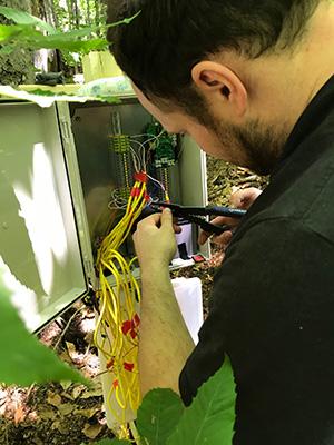 Dr. Dave Lutz, Dartmouth College, installing sensors to data collection board engineered specifically for this study. Photo Credit: Chris Woodall, USDA Forest Service Northern Research Station